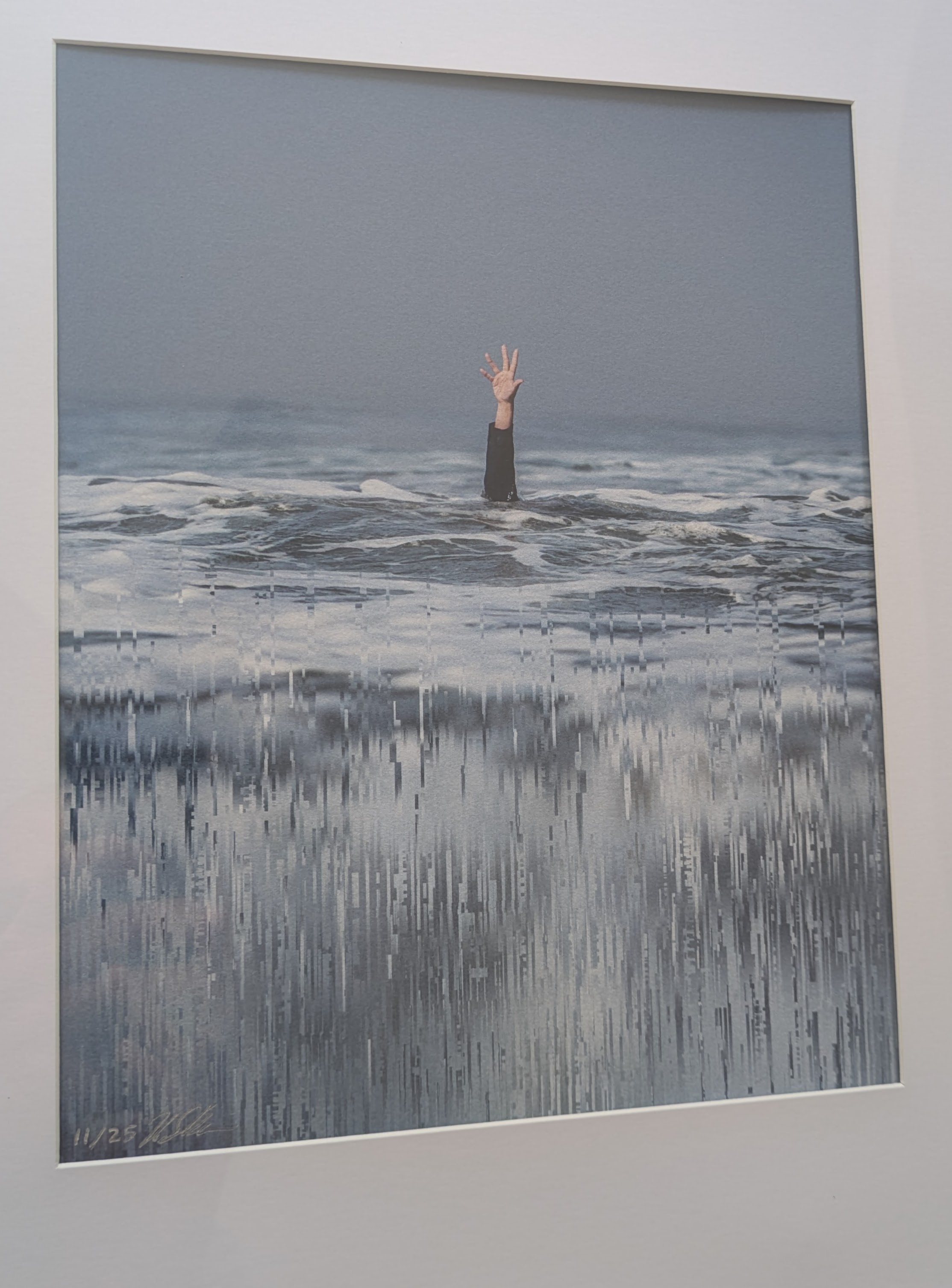 A print of Rob Sheridan's 'Reach' in a frame