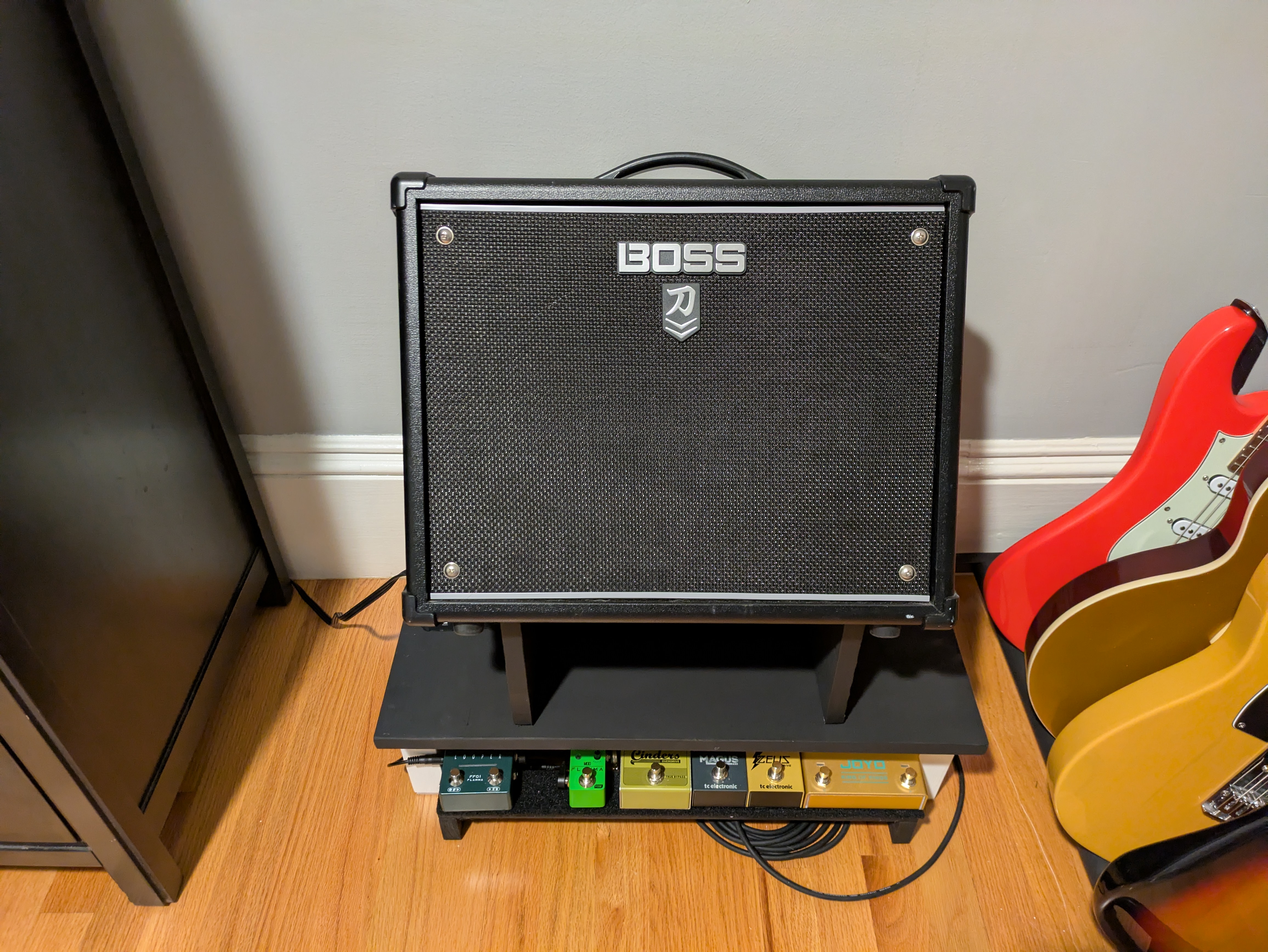 The pedalboard tucked under the platform