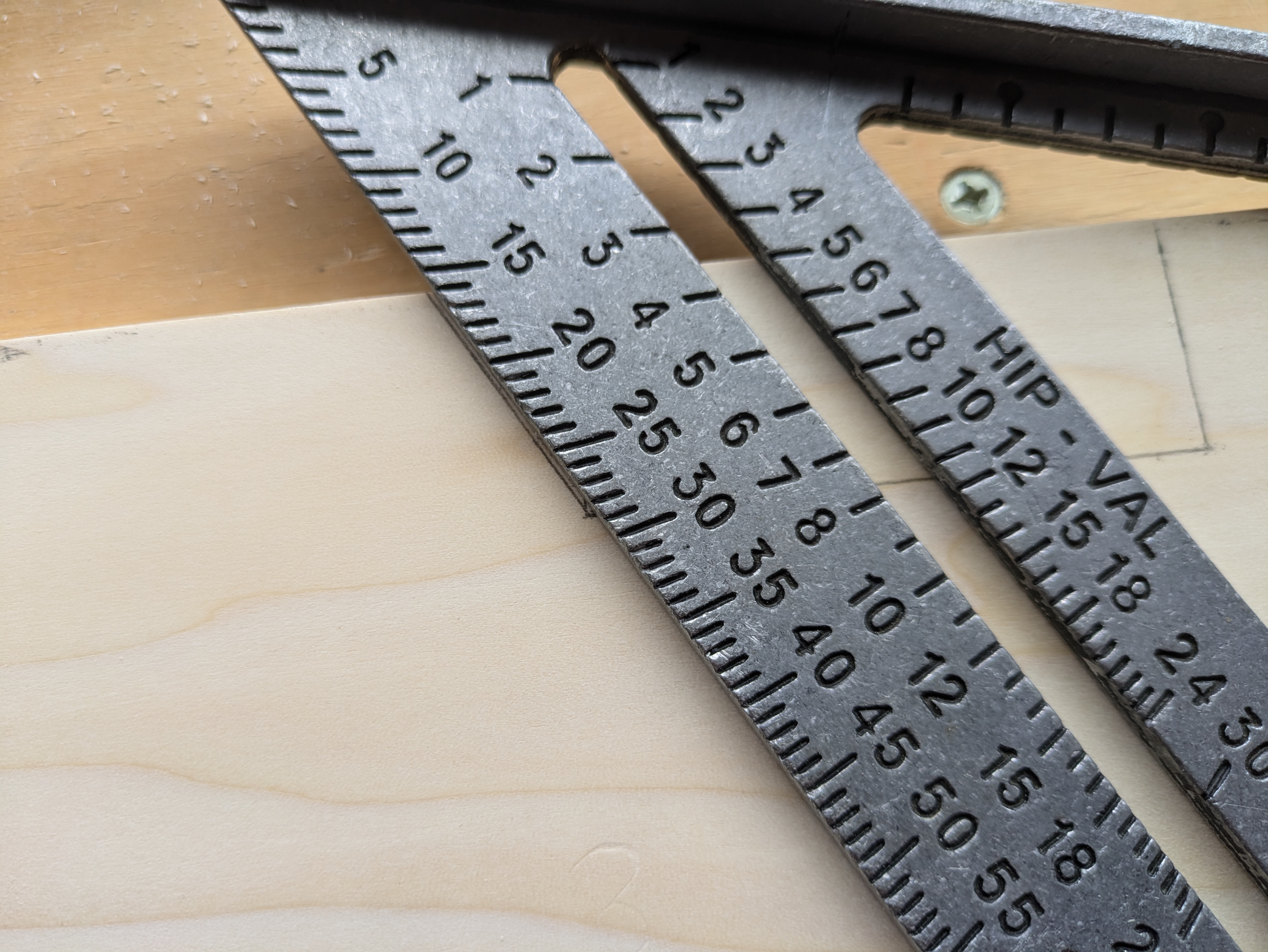 A speed square tilted to measure an angled cut