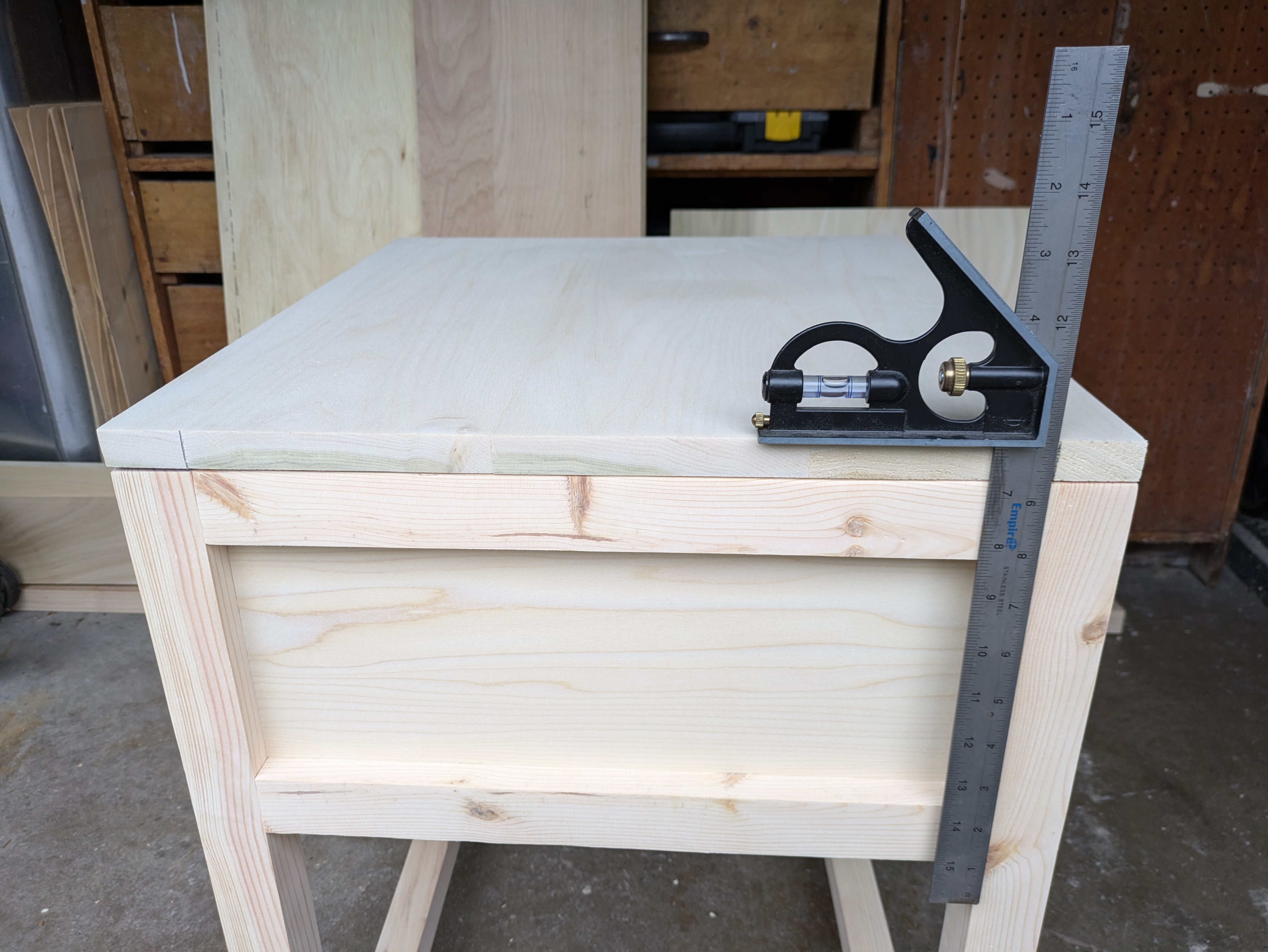 Lining up the table legs with the bottom shelf to know where to cut