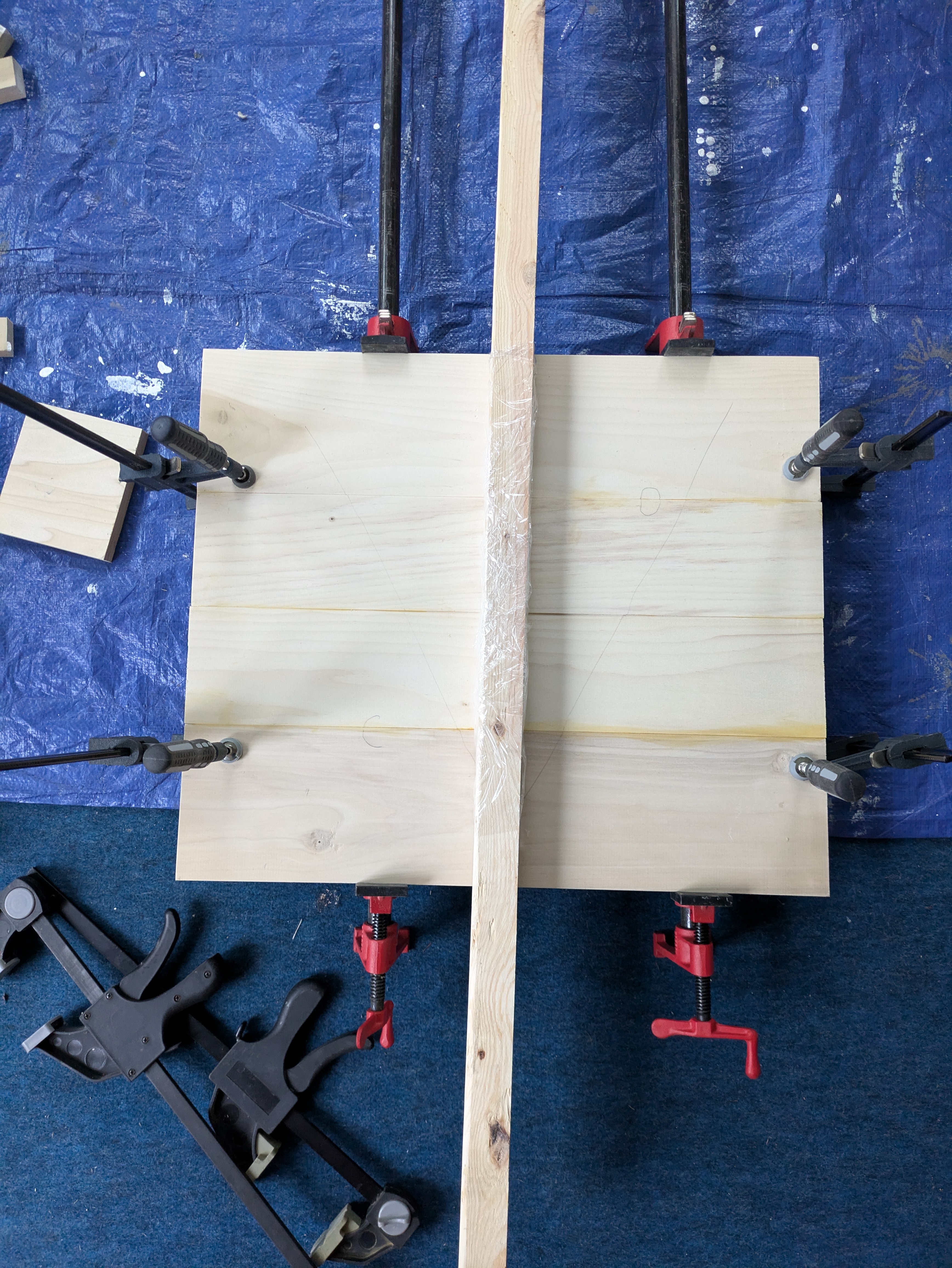 A table top in clamps after being glued together