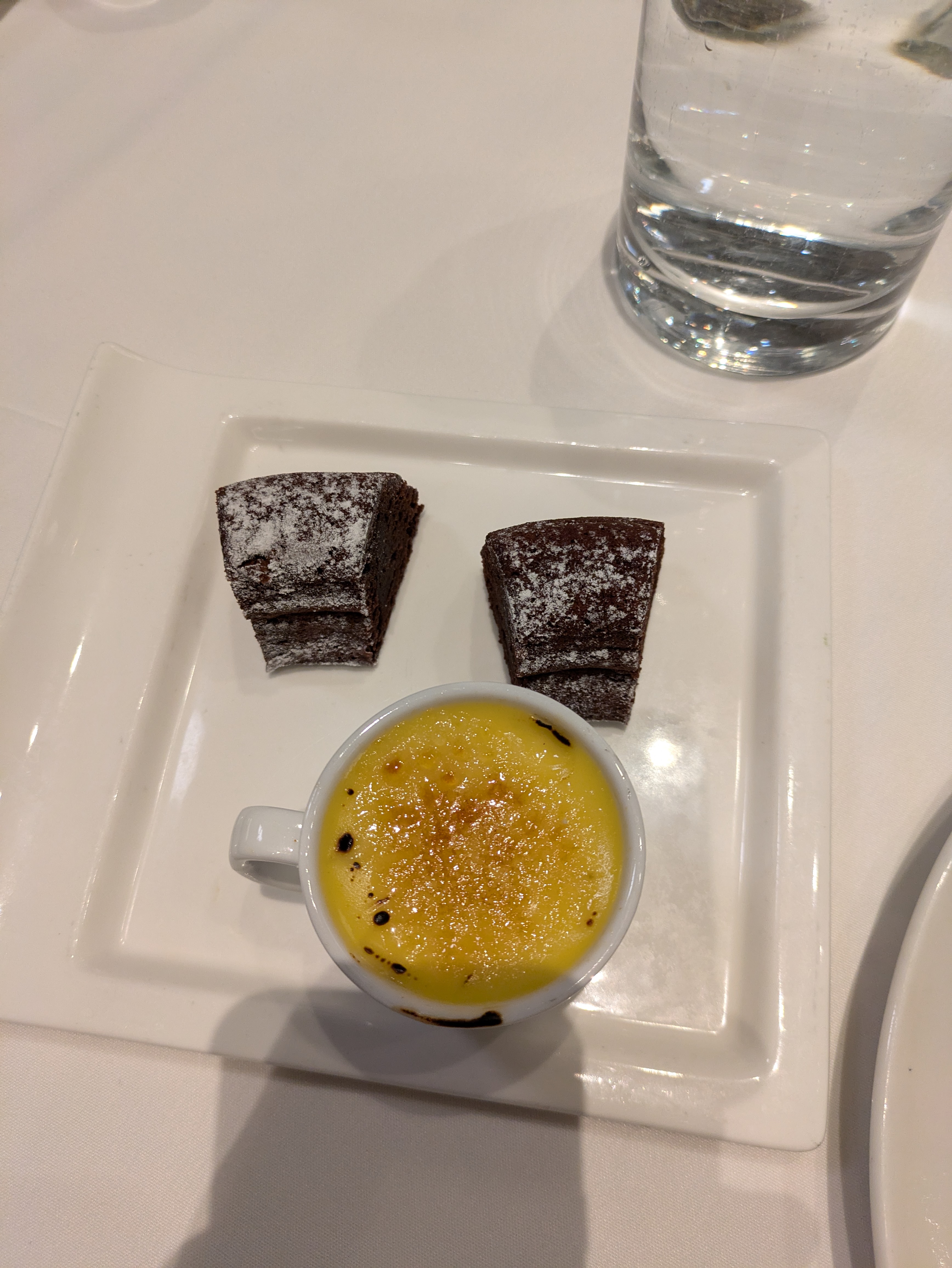 A serving of creme brulee and chocolate cake