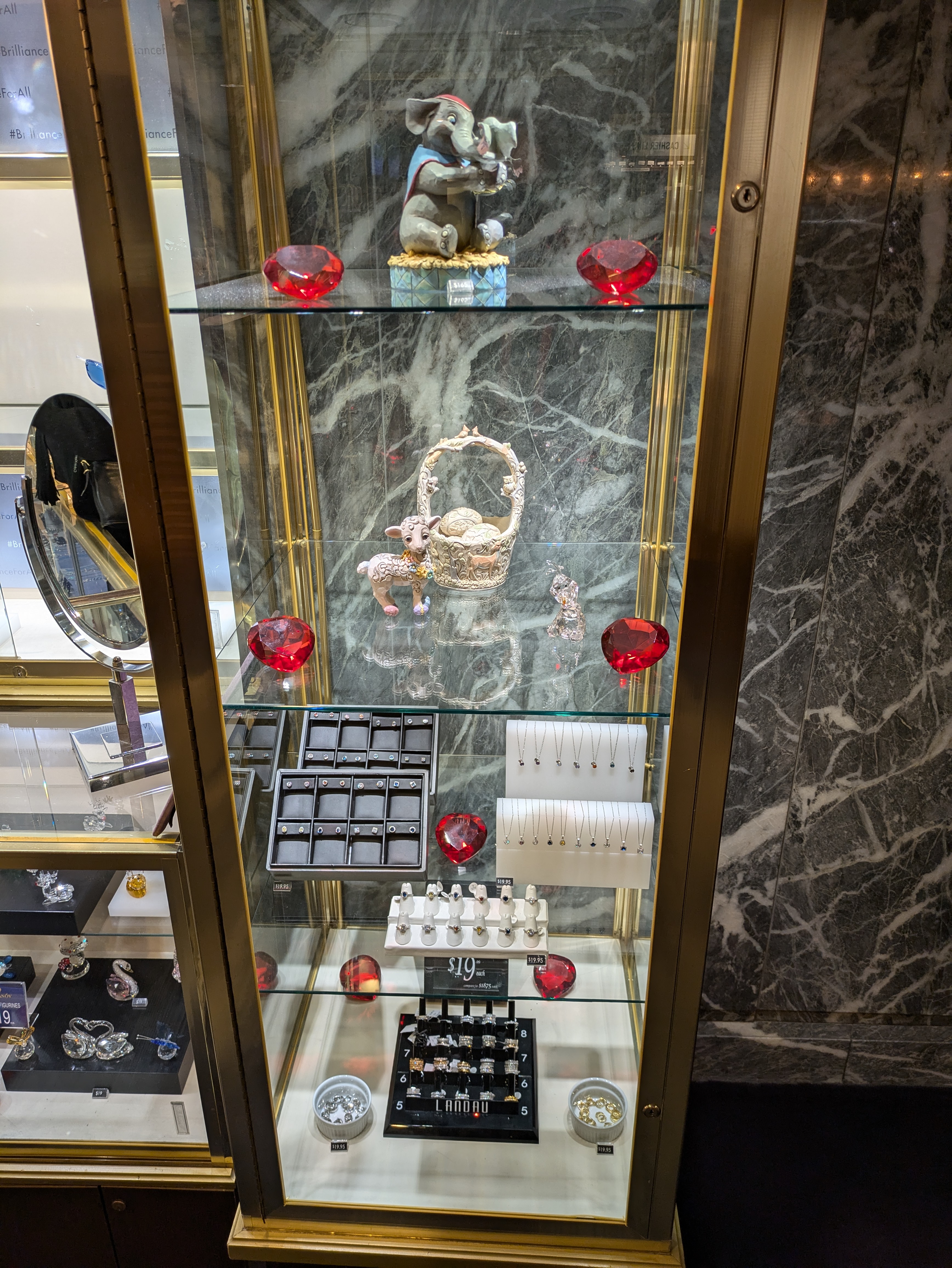 A display case with jewelry and trinkets that displays large rubies